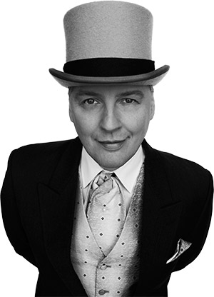Bjössi Greifi smiling in a top hat